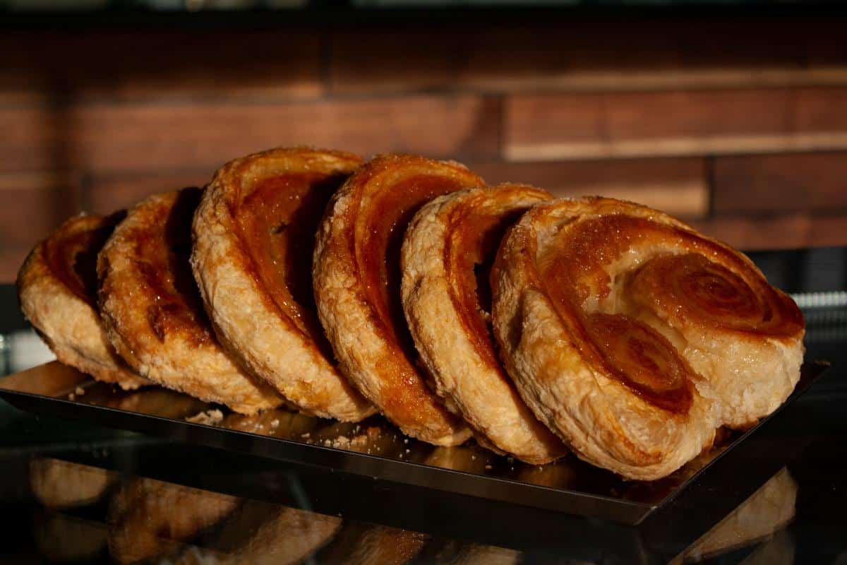 Close-up of golden spiral pastries on a tray at Bagel Chicks near Charles Town.