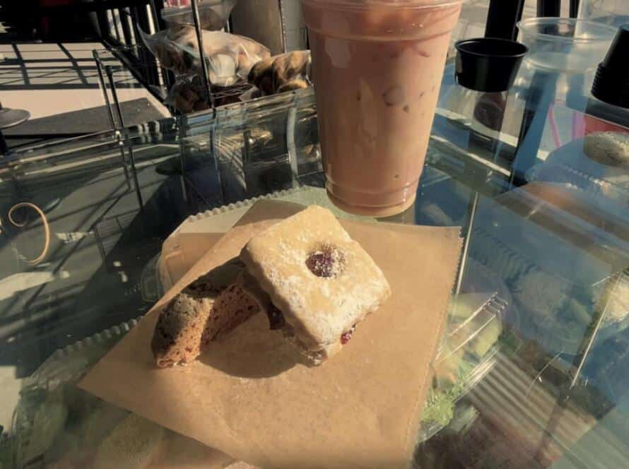 Holiday traditions at Bagel Chicks featuring a festive pastry and iced drink, celebrating food, community, and holiday spirit.