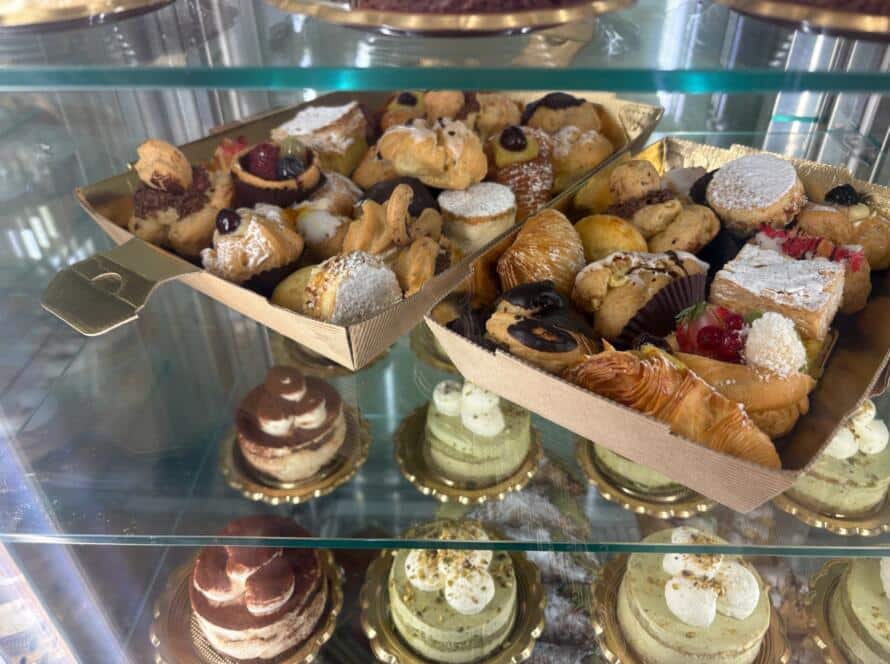 From dough to delicious at Bagel Chicks, featuring a bakery display filled with assorted pastries and desserts that highlight the art of bagel-making and handcrafted baking.