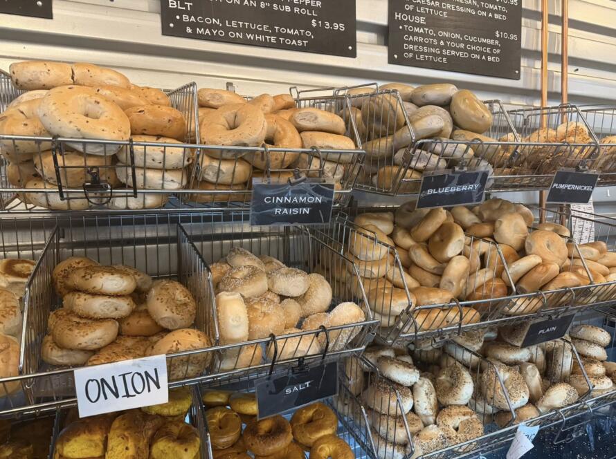 Fresh bagels in multiple flavors stacked in labeled baskets at Bagel Chicks, a growing breakfast favorite in West Virginia and Northern Virginia.