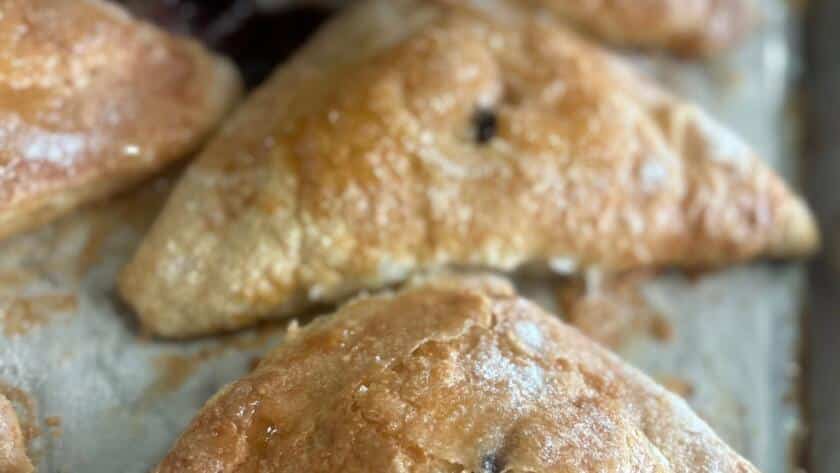 Close-up of a golden baked pastry from the Bagel Chicks Menu, a sweet option to order on your first visit.