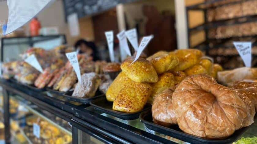 Freshly baked bagels and breads displayed inside a family bakery.