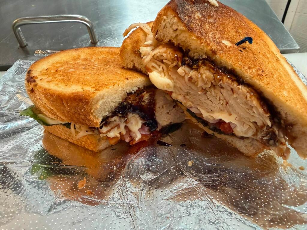 Loaded turkey sandwich with cheese, vegetables, and sauce as a drive-thru alternative